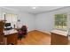 Office room featuring hardwood floors, natural lighting, and a desk with a rolling chair at 137 Vaiden Rd, Louisburg, NC 27549