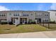 Townhome backyard with screened porches, grassy area, and a small black metal fence at 1394 Southpoint Trl, Durham, NC 27713