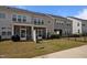 Townhome backyard with screened porches, grassy area, and a small black metal fence at 1394 Southpoint Trl, Durham, NC 27713