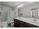 Well-lit bathroom with a double vanity, shower-tub combo, and stylish mermaid-themed shower curtain at 1394 Southpoint Trl, Durham, NC 27713