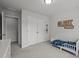 Neutral-toned bedroom with a closet, toddler bed, and 'Clark Thomas' decoration, offering a serene space at 1394 Southpoint Trl, Durham, NC 27713