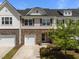 Charming townhome with stone accents, a single-car garage, and a well-maintained front yard at 1394 Southpoint Trl, Durham, NC 27713