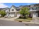 A row of modern townhomes featuring stone accents, white siding, and attached garages at 1394 Southpoint Trl, Durham, NC 27713