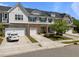 A row of modern townhomes featuring stone accents, white siding, and attached garages at 1394 Southpoint Trl, Durham, NC 27713