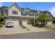 A row of modern townhomes featuring stone accents, white siding, and attached garages at 1394 Southpoint Trl, Durham, NC 27713