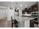 Modern kitchen boasts granite counters, stainless appliances, pendant lighting, and dark cabinetry for style and function at 1394 Southpoint Trl, Durham, NC 27713