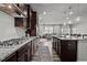 Modern kitchen featuring a gas cooktop, granite counters, stainless appliances, and an open design for modern living at 1394 Southpoint Trl, Durham, NC 27713