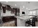 Modern kitchen featuring granite counters, stainless appliances, pendant lighting, and dark cabinetry for style and function at 1394 Southpoint Trl, Durham, NC 27713