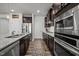 Modern kitchen featuring granite counters, stainless appliances, and ample dark cabinetry for a functional design at 1394 Southpoint Trl, Durham, NC 27713
