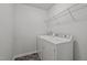 Functional laundry area equipped with a washer, dryer, and overhead shelving for efficient organization at 1394 Southpoint Trl, Durham, NC 27713