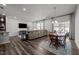 Comfortable living room featuring modern appliances, a large sectional couch, and a dining area for relaxation at 1394 Southpoint Trl, Durham, NC 27713
