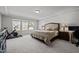 Relaxing main bedroom with soft carpeting, tray ceiling, and large windows for plenty of natural light at 1394 Southpoint Trl, Durham, NC 27713