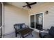 Covered patio featuring comfortable seating, ceiling fan, and sliding door for a cozy outdoor experience at 1394 Southpoint Trl, Durham, NC 27713