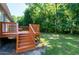 This angle highlights the home's beautiful deck, perfect for enjoying the lush, green surroundings at 1443 Smokey Mountain Dr, Zebulon, NC 27597