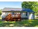 View of the home's backyard, showing the deck, well-maintained lawn, and mature trees at 1443 Smokey Mountain Dr, Zebulon, NC 27597
