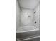 This bathroom features a tub and shower with a marble tiled shower, chrome fixtures, and a built-in niche at 1443 Smokey Mountain Dr, Zebulon, NC 27597