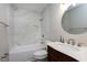 This bathroom features a marble tiled tub and shower, chrome fixtures, and a vintage vanity at 1443 Smokey Mountain Dr, Zebulon, NC 27597