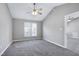 Bright bedroom boasts vaulted ceiling, ceiling fan, plush carpeting, and double windows at 1443 Smokey Mountain Dr, Zebulon, NC 27597