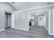 Open-concept living space leading to a kitchen, with neutral walls and modern flooring at 1443 Smokey Mountain Dr, Zebulon, NC 27597