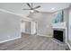 Bright living room with vaulted ceiling, neutral walls, a fireplace, and modern ceiling fan at 1443 Smokey Mountain Dr, Zebulon, NC 27597