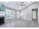 Cozy living room featuring a fireplace, updated flooring, and ample natural light at 1443 Smokey Mountain Dr, Zebulon, NC 27597