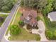 Aerial view of a large home with mature trees, a long driveway, and well-kept landscaping at 1508 Samuel Wait Ln, Wake Forest, NC 27587