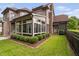 Beautiful backyard featuring a screened porch, stone chimney, and privacy landscaping at 1508 Samuel Wait Ln, Wake Forest, NC 27587
