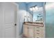 A vanity with a marble countertop features storage, great lighting, and tile floors in this well-kept bathroom at 1508 Samuel Wait Ln, Wake Forest, NC 27587