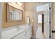 Well-lit bathroom featuring custom cabinets, a chrome faucet, tile floors, and an adjacent room with dark wooden furnishings at 1508 Samuel Wait Ln, Wake Forest, NC 27587