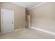 Bedroom with neutral carpet, base trim, and two white doors for closets and ensuite at 1508 Samuel Wait Ln, Wake Forest, NC 27587