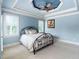 Bedroom with a light blue color scheme, tray ceiling, and metal frame bed at 1508 Samuel Wait Ln, Wake Forest, NC 27587