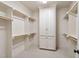 Spacious walk-in closet with custom shelving, ample hanging space, and a central cabinet for optimal organization at 1508 Samuel Wait Ln, Wake Forest, NC 27587