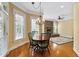 Open dining area features a fireplace, large windows offering ample natural light, and beautiful hardwood floors at 1508 Samuel Wait Ln, Wake Forest, NC 27587