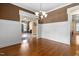 Formal dining room boasts wainscoting, hardwood floors, and views to the living room at 1508 Samuel Wait Ln, Wake Forest, NC 27587