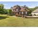 Stunning two-story home featuring stone and siding, a well-manicured lawn, and beautiful landscaping at 1508 Samuel Wait Ln, Wake Forest, NC 27587