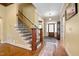 Grand foyer features hardwood floors, elegant staircase with iron balusters, and a decorative rug at 1508 Samuel Wait Ln, Wake Forest, NC 27587
