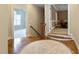 Foyer with wood floors and staircase leading to a brightly lit landing at 1508 Samuel Wait Ln, Wake Forest, NC 27587