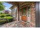 Charming front entrance with stone accents, a wooden door, and well-maintained landscaping at 1508 Samuel Wait Ln, Wake Forest, NC 27587