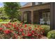 Charming front porch with stone columns and blooming red roses enhances curb appeal at 1508 Samuel Wait Ln, Wake Forest, NC 27587