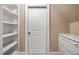 Hallway with a white door, built-in shelves, and drawers provides ample storage space at 1508 Samuel Wait Ln, Wake Forest, NC 27587