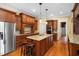Spacious kitchen with a large island, stainless steel appliances, and custom cabinetry at 1508 Samuel Wait Ln, Wake Forest, NC 27587