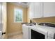 Laundry room with a utility sink and a front-load washer and dryer set at 1508 Samuel Wait Ln, Wake Forest, NC 27587