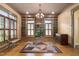Bright living room showcases custom built-ins, plantation shutters, a large geometric rug, and hardwood floors at 1508 Samuel Wait Ln, Wake Forest, NC 27587
