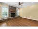 Living room with stacked stone fireplace, hardwood floors, and double-hung windows at 1508 Samuel Wait Ln, Wake Forest, NC 27587