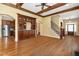 Open living room with hardwood floors, wet bar, stairs, and view into the kitchen at 1508 Samuel Wait Ln, Wake Forest, NC 27587