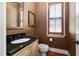 Charming powder room with a dark granite countertop and bronze fixtures at 1508 Samuel Wait Ln, Wake Forest, NC 27587