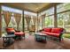 Bright sunroom with wicker furniture and large windows offers a relaxing space to enjoy the outdoors at 1508 Samuel Wait Ln, Wake Forest, NC 27587