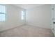 Light-filled bedroom featuring neutral carpet and windows with blinds at 151 Monteith Dr, Chapel Hill, NC 27516