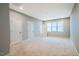 Large carpeted bonus room with plenty of light and multiple doors, offering a versatile space for recreation or relaxation at 151 Monteith Dr, Chapel Hill, NC 27516
