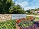 Landscaped entrance to Briar Chapel community, featuring stone wall and colorful flower beds at 151 Monteith Dr, Chapel Hill, NC 27516